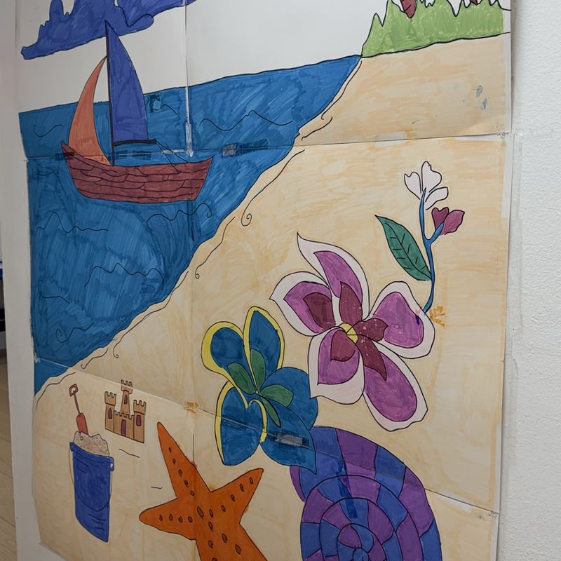 A painted beach scene with a sailboat, starfish, sea turtle, and shells