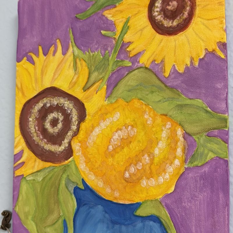 Sunflowers painted in gold and green against a purple background