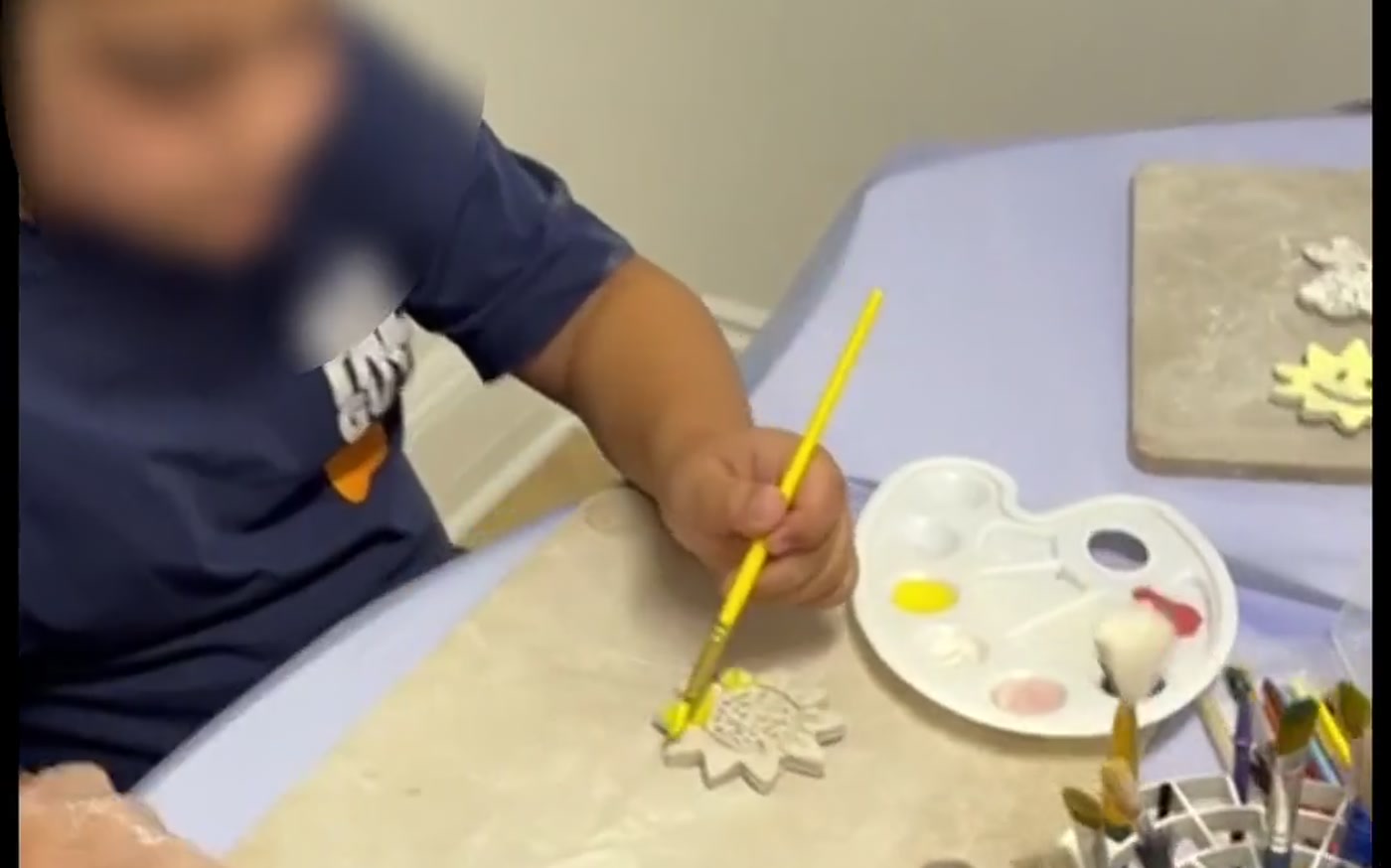 A child shaping clay in a Glendale pottery class