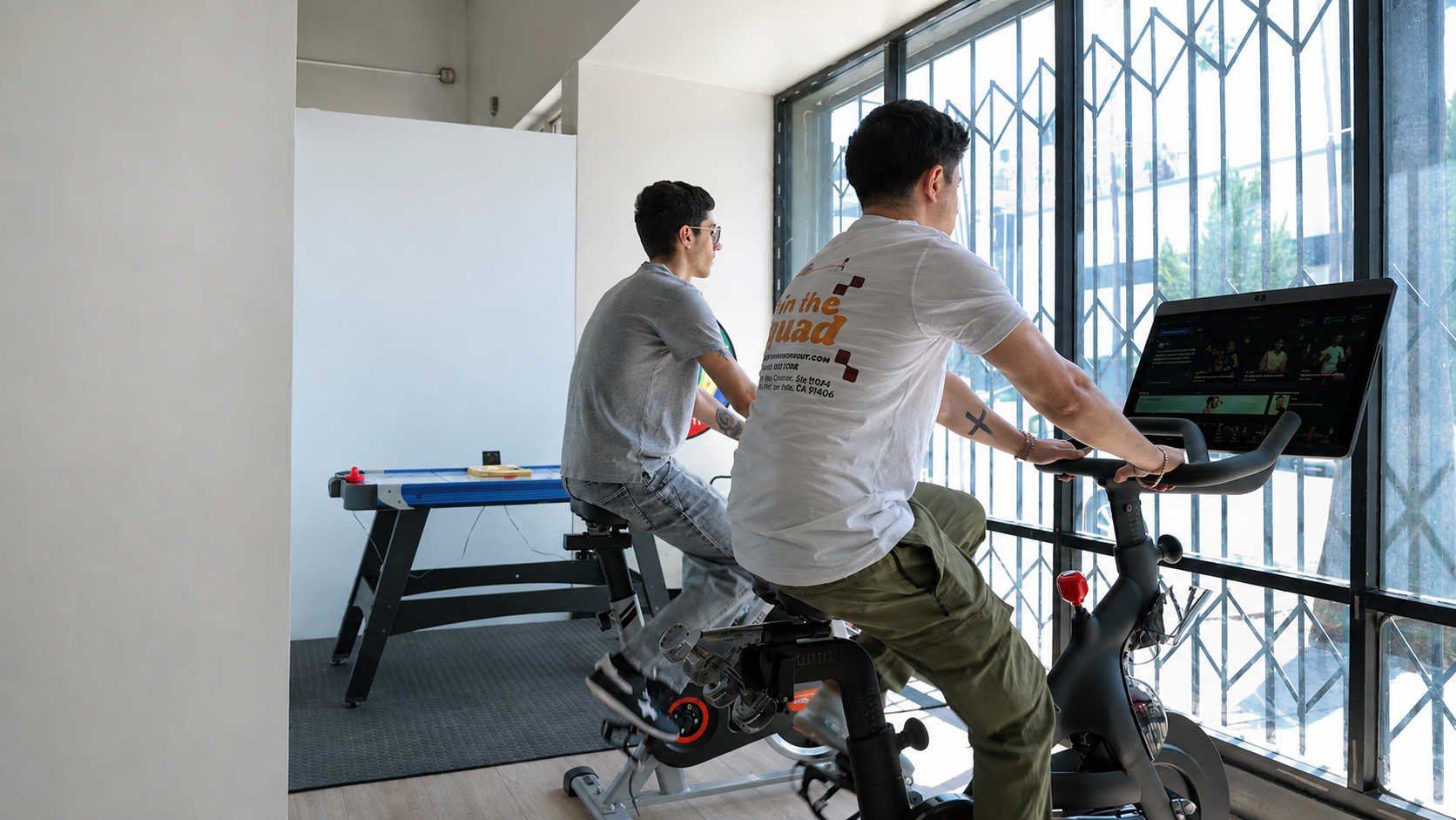 Two participants exercising together on stationary bikes
