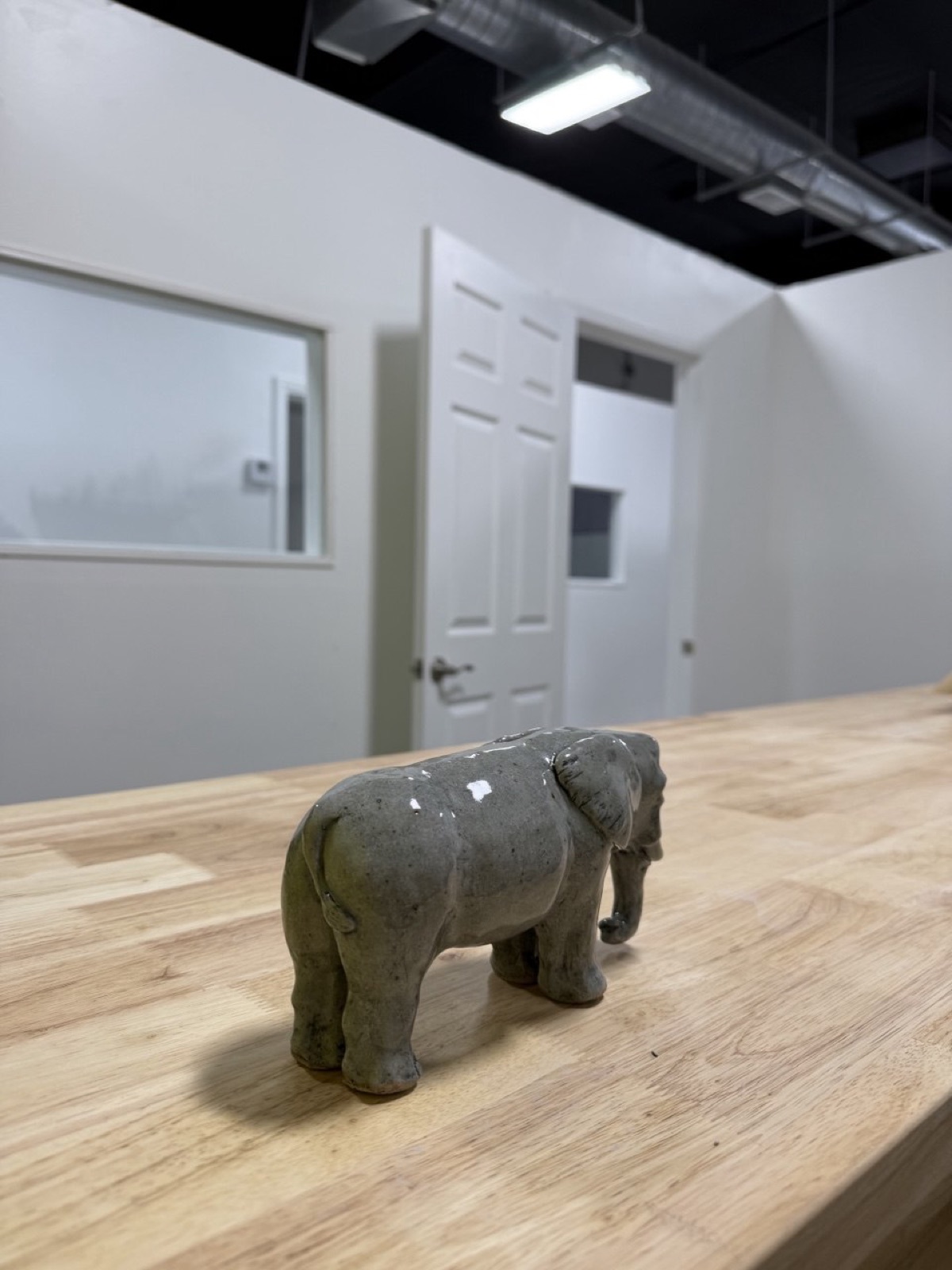 A hand-sculpted clay elephant displayed on the studio table, Van Nuys
