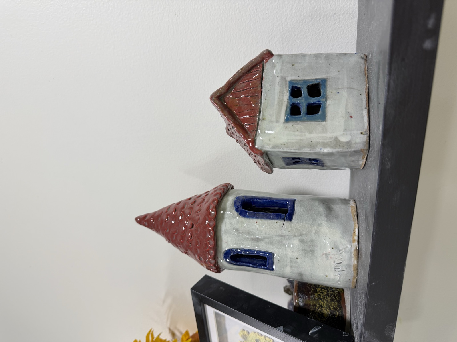 Two hand-built clay cottages with red roofs and blue windows, made in our Van Nuys pottery studio