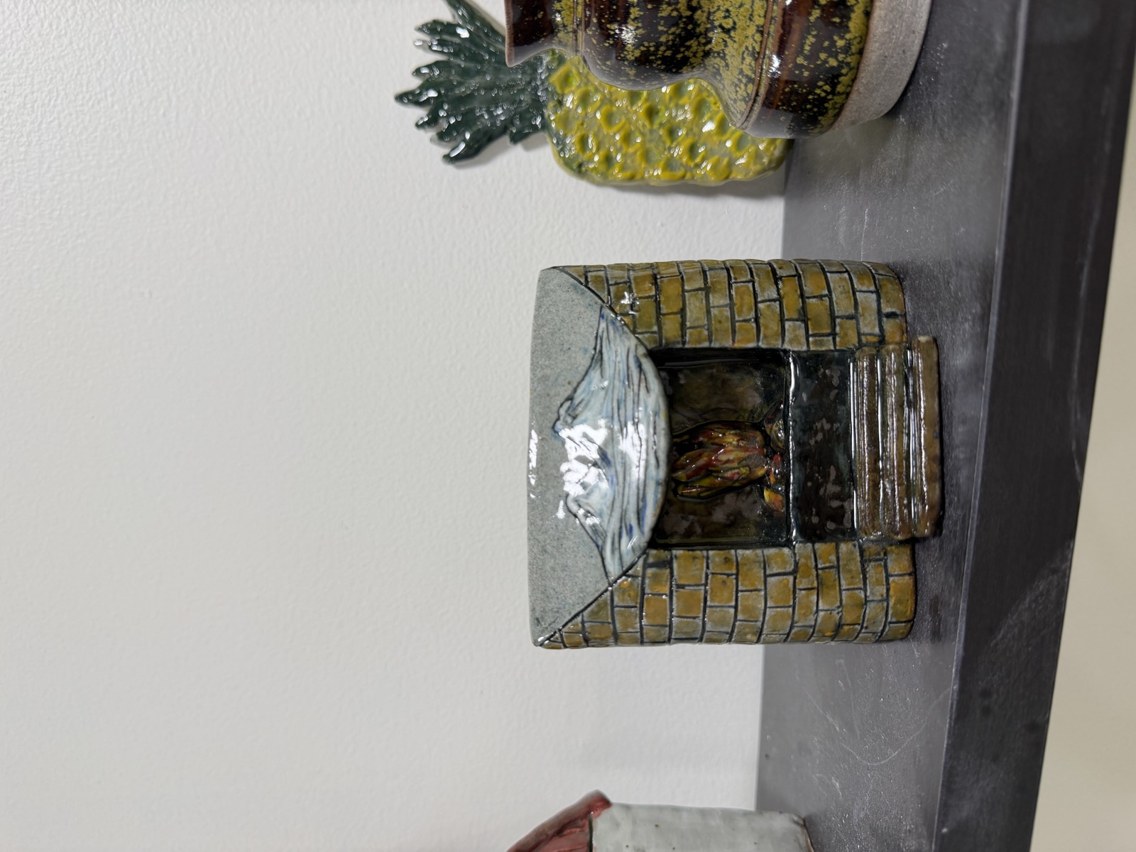 A clay fireplace sculpted with a brick pattern and painted by hand