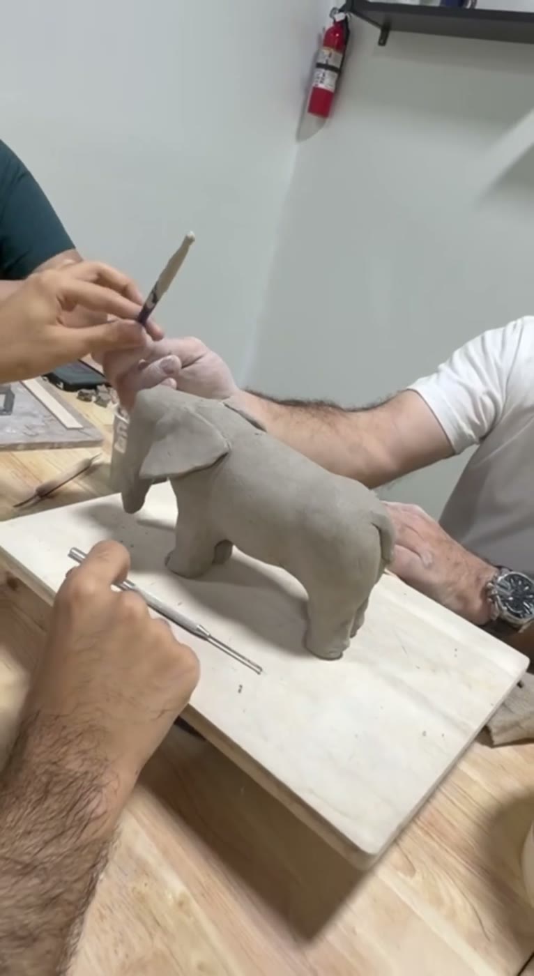 Sculpting a clay horse with modeling tools — adult pottery class, Van Nuys