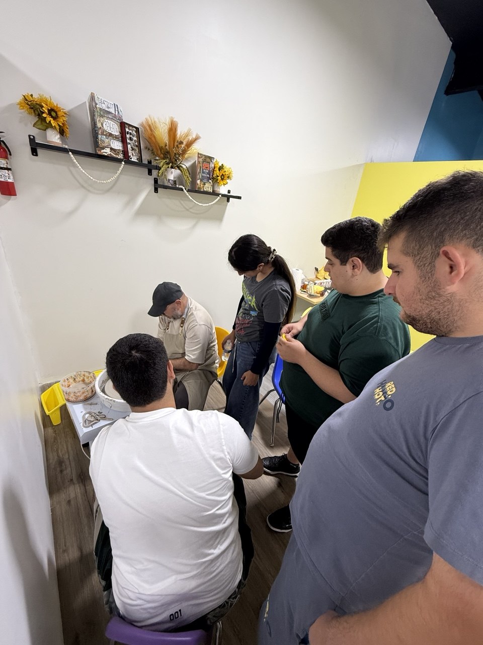 Children and instructors working together in the Glendale pottery room