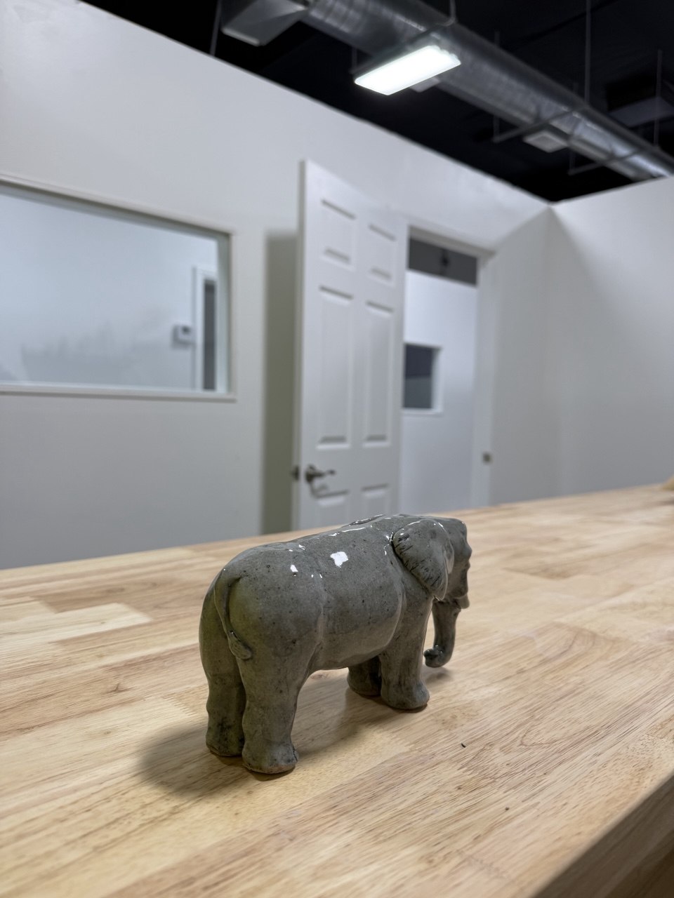 Finished clay elephant on a pottery classroom table in Glendale