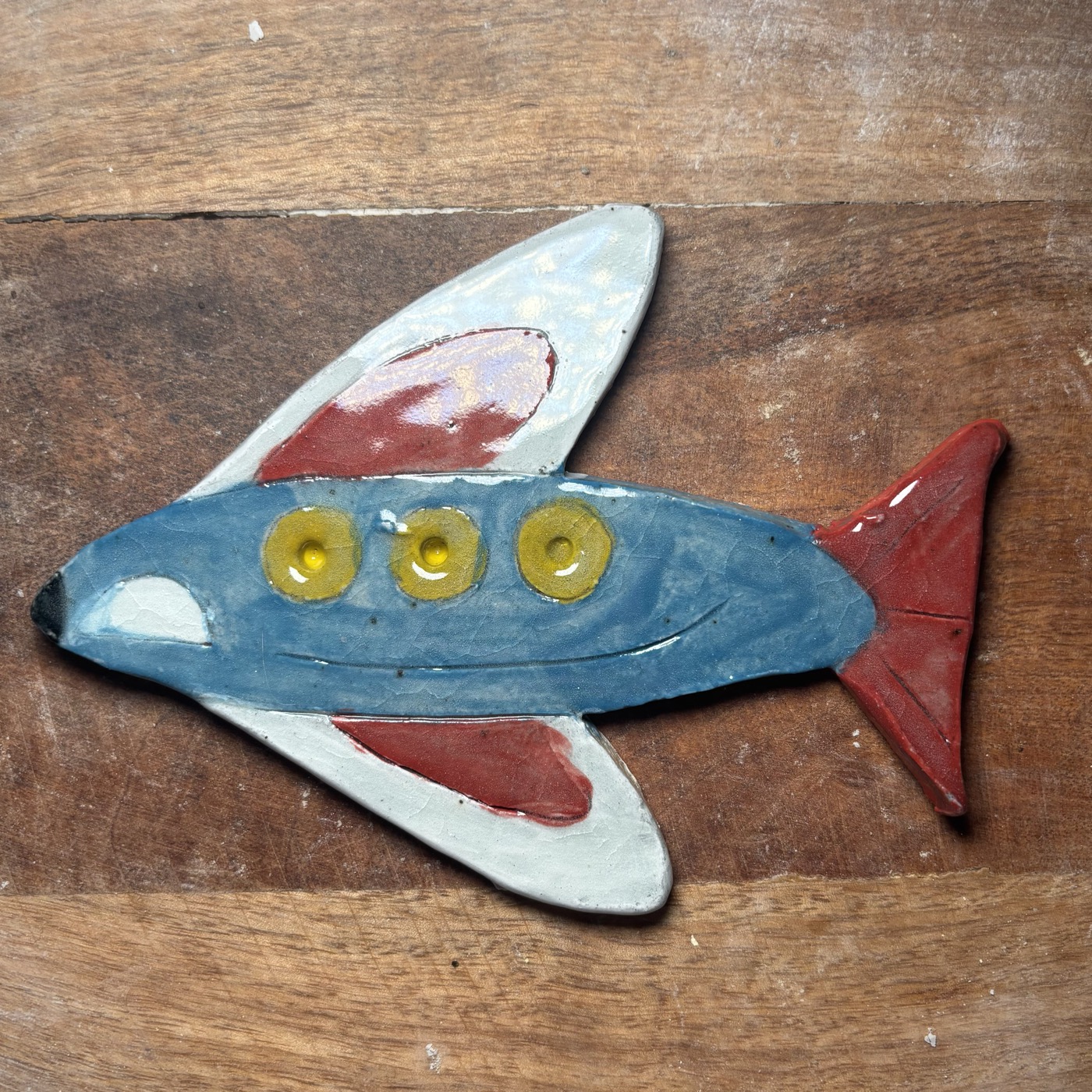 Hand-painted clay airplane by a young artist