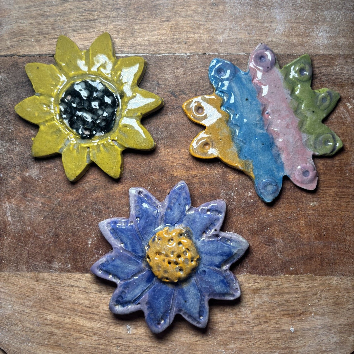 Clay sunflower, butterfly, and flower pieces by young artists
