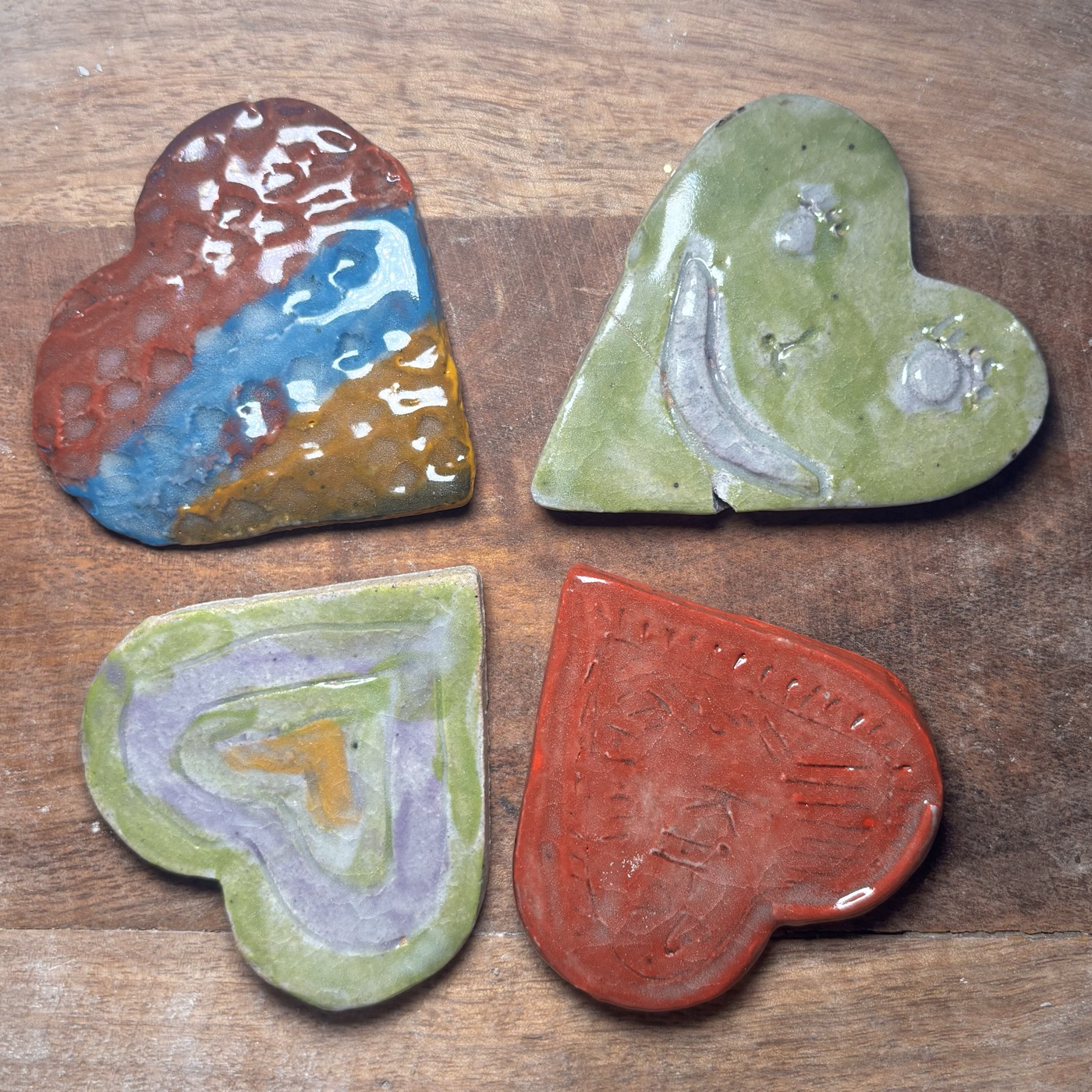Hand-painted clay hearts in four designs