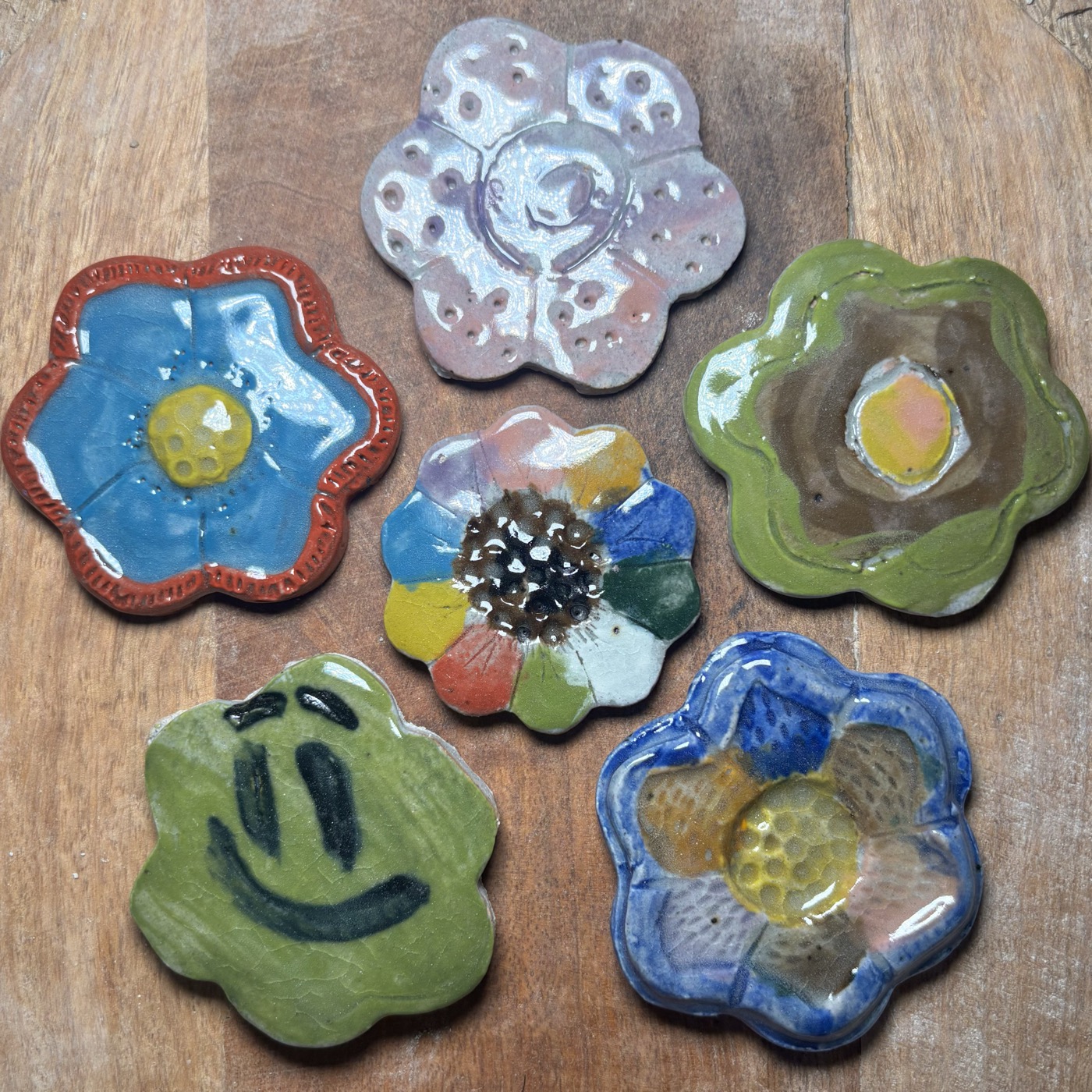 A tabletop of hand-painted clay flowers