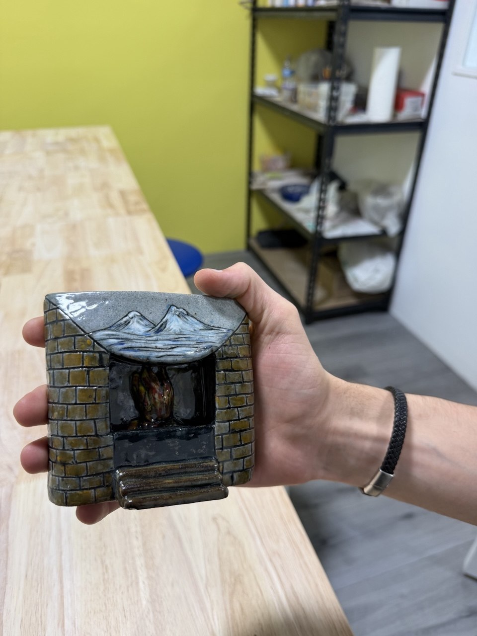 Hand-painted detail on a finished clay fireplace sculpture