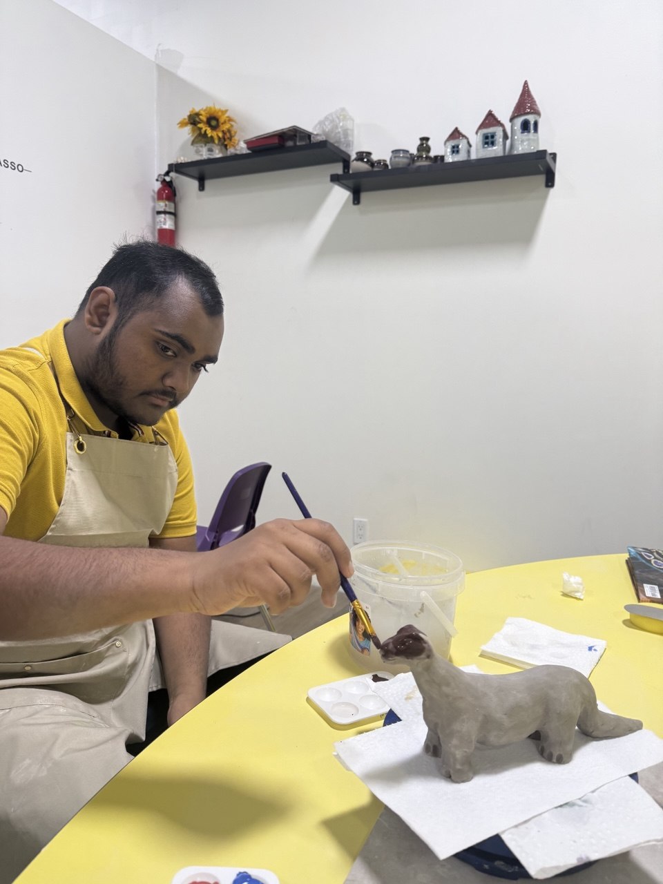 An adult painting a clay creation during pottery in Van Nuys