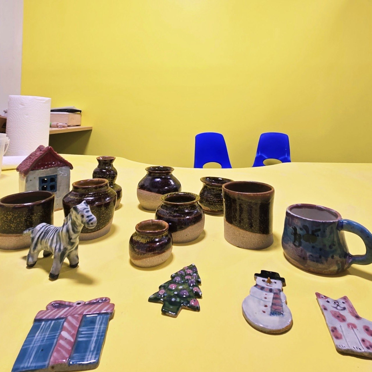 Finished pottery pieces arranged on a Van Nuys studio table