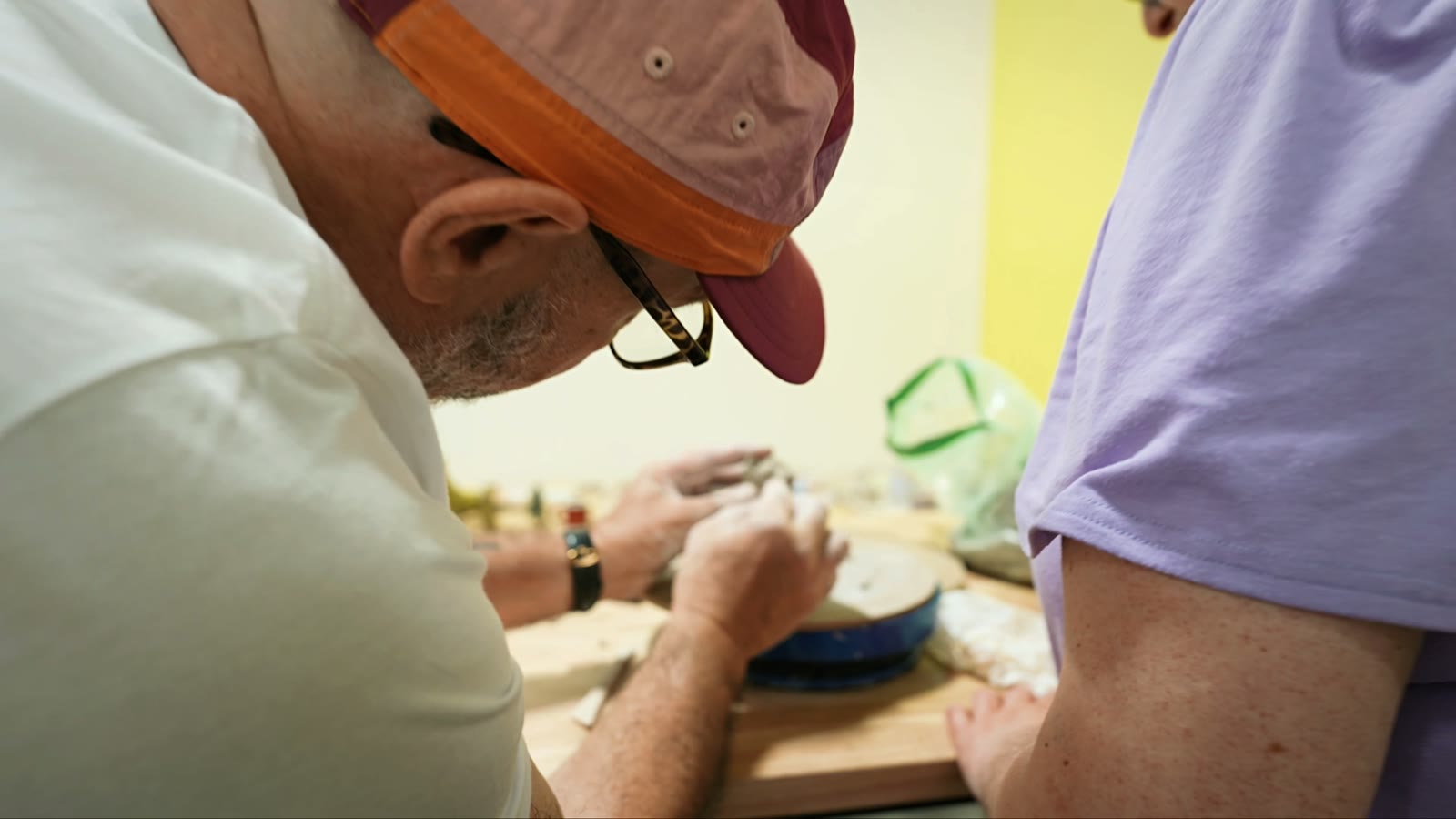 Adults shaping and sculpting clay in the pottery studio at the Van Nuys center