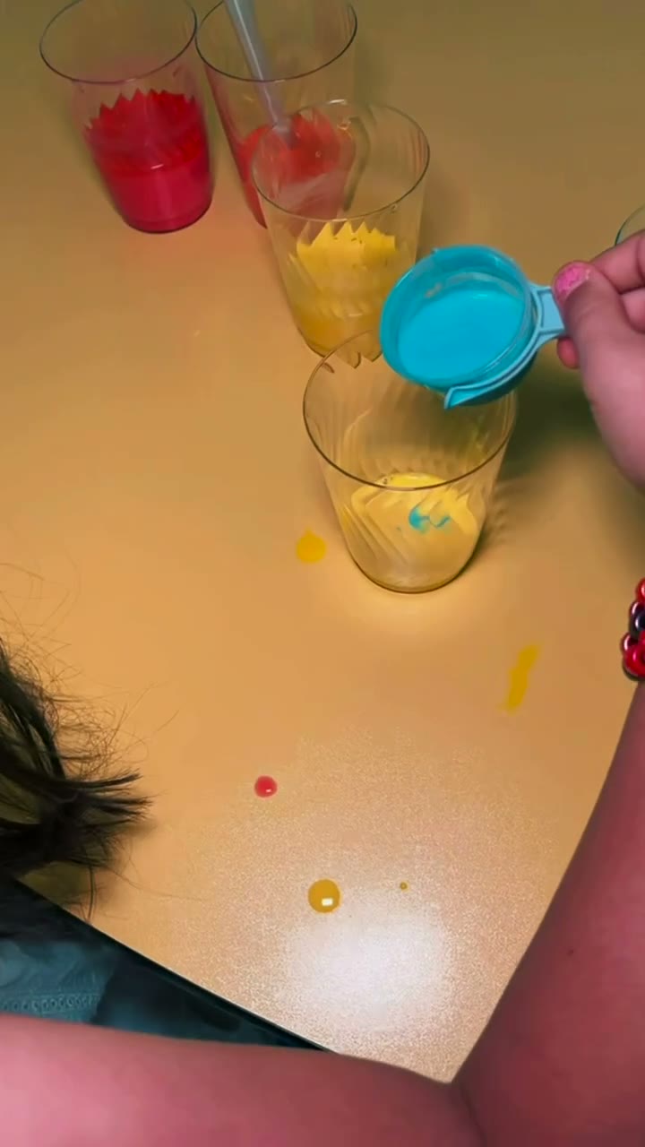 Children mixing paint colors at a sensory-friendly art class in Glendale