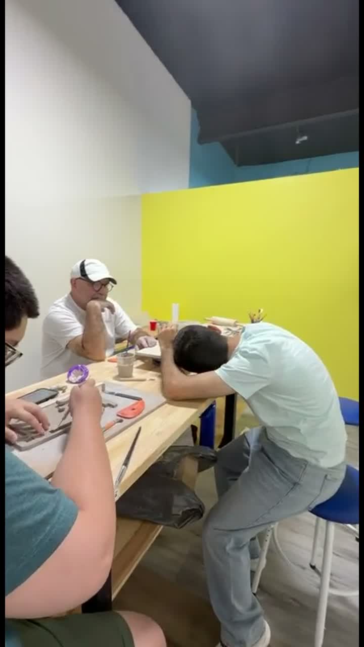 Adults working with clay together in the Van Nuys pottery studio