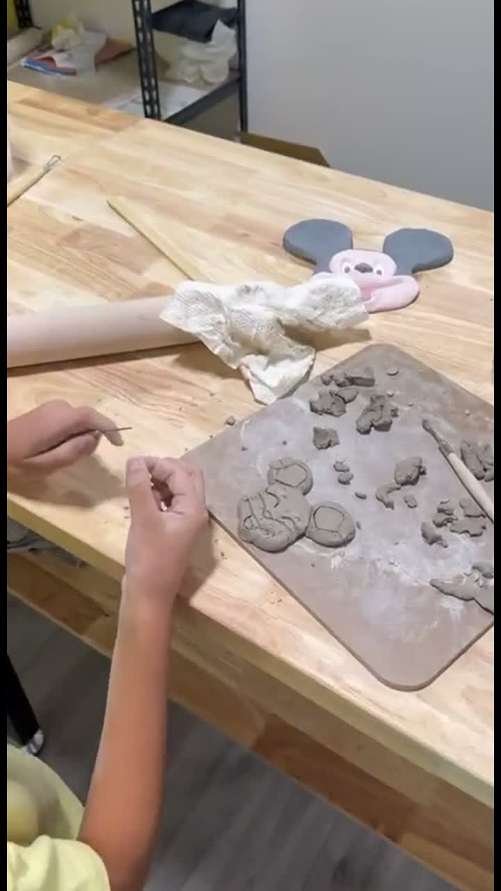 Hands adding details to a clay creation in the Van Nuys studio