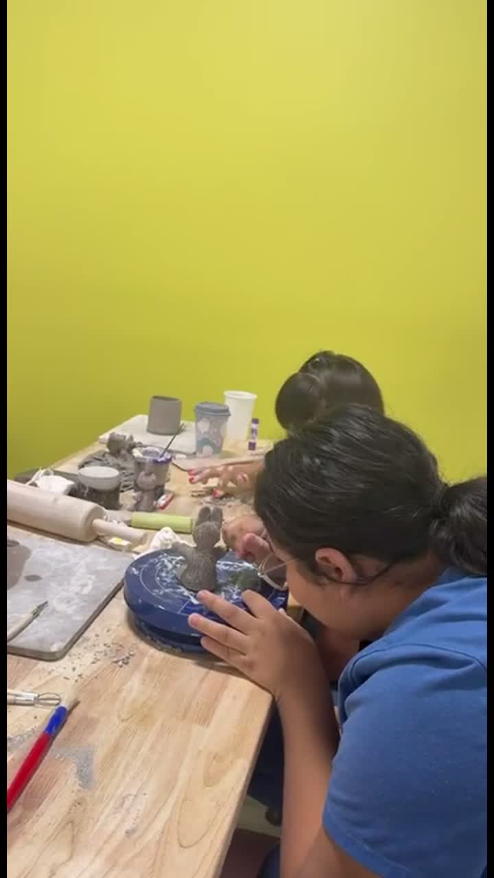 A participant shaping a clay piece during pottery in Van Nuys