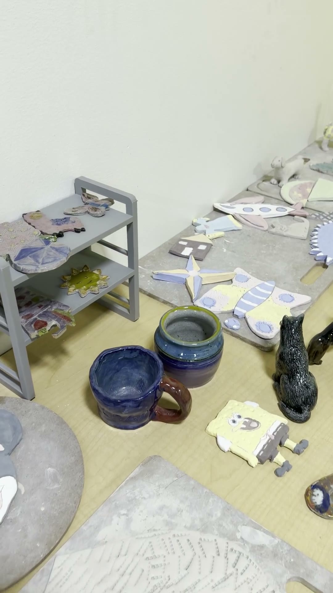 A short pottery reel of sculpting, detailing, and finished work