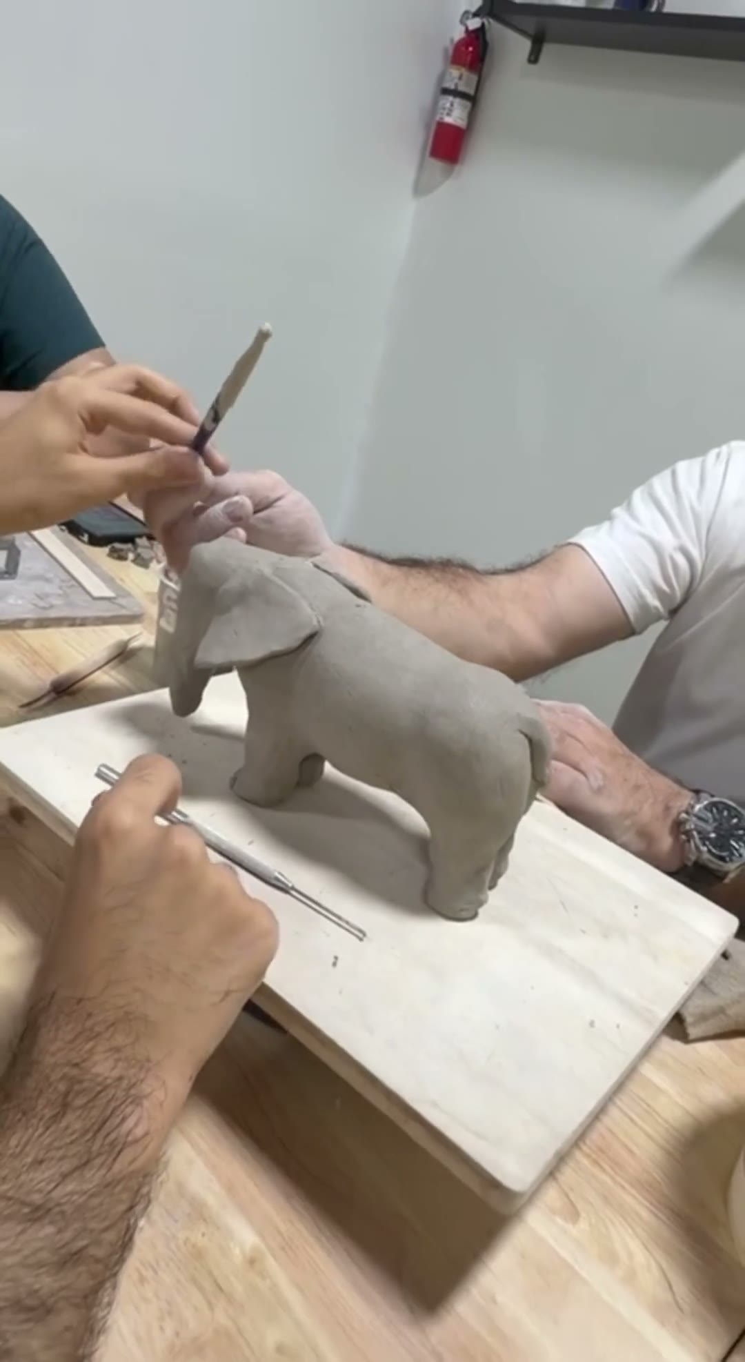 Young adults shaping and painting clay at our Van Nuys pottery session