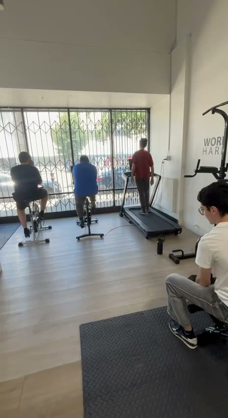 Adults using bikes and a treadmill during a Van Nuys fitness session