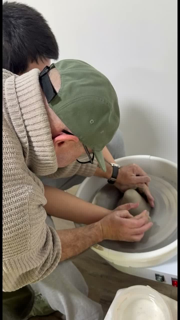 Adults shaping clay together during a pottery session in Van Nuys